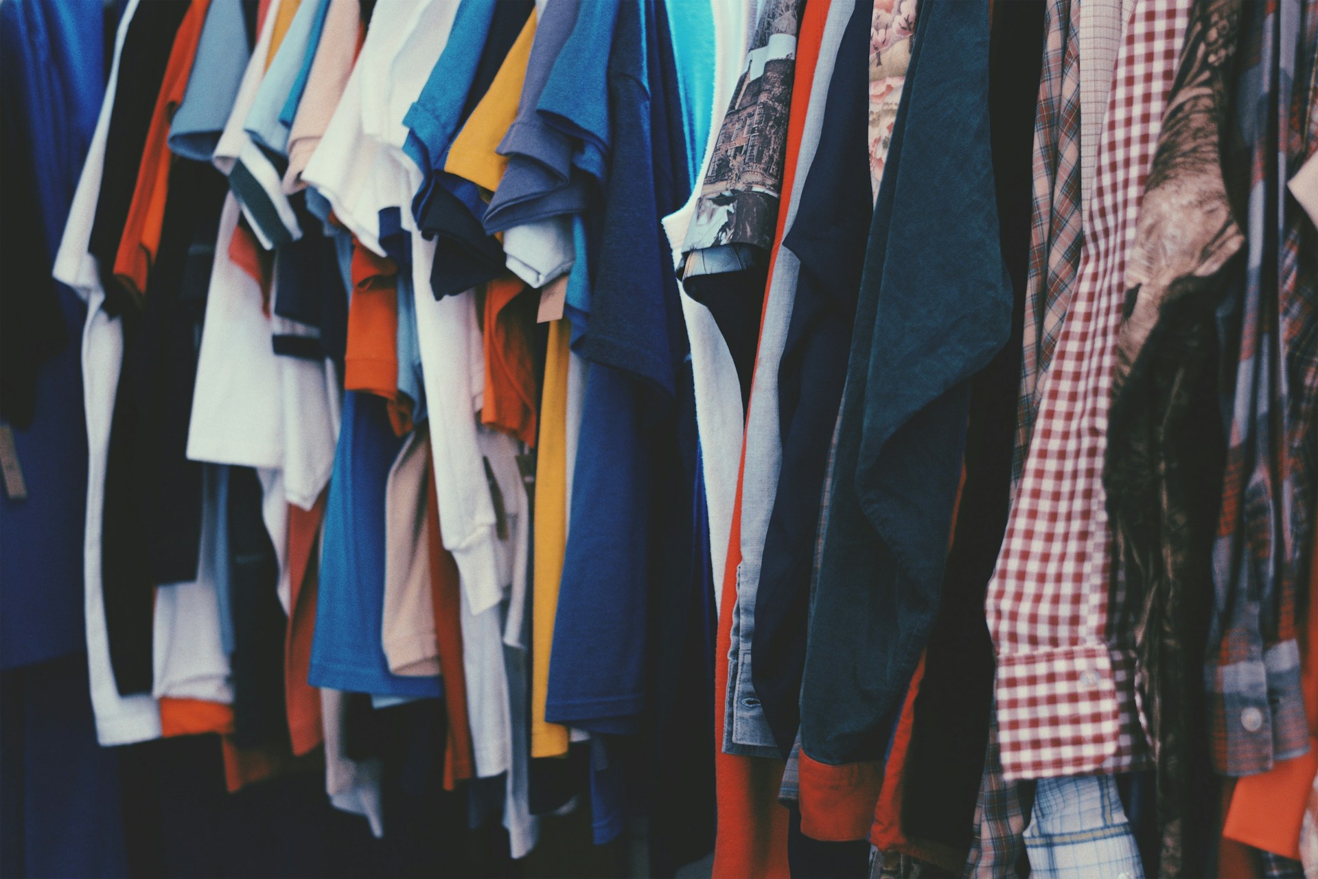 Selection of clothing in different fabrics and styles on a rack